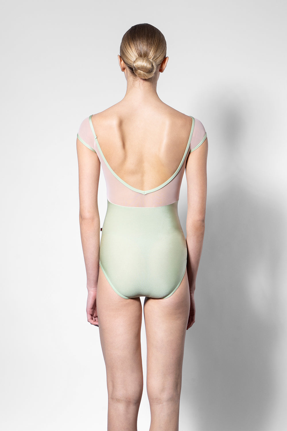 Elli leotard in N-Ginko body color with V-Blush top color, Mesh Blush cap sleeves and N-Ginko trim color