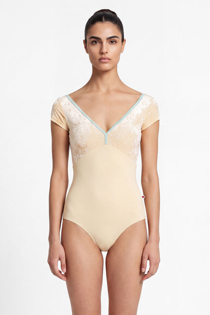 AI-generated model. Alicia leotard, vanilla yellow with a vanilla yelllow crushed-velvet cap-sleeve bodice and pale-mint V-neck trim.