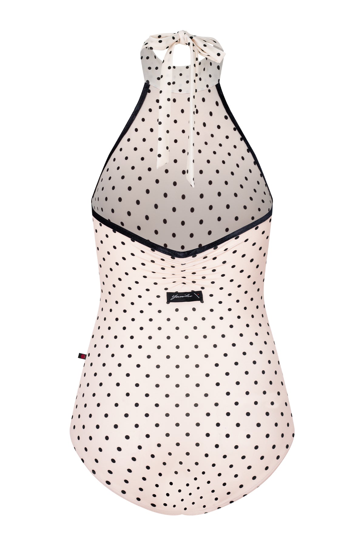 AI-generated model. Kelly leotard, all-over T-Lunares Cream polka-dot with a black-trimmed high halter neck and open sides.