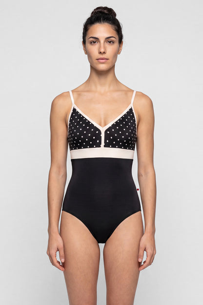 AI-generated model. Zoe leotard, black T-Lunares polka-dot V-neck bust with blush straps and waistband, black body.