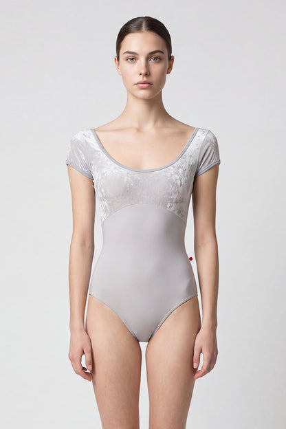 AI-generated model. Anna Duo leotard, silver-grey crushed-velvet cap-sleeve bodice and a grey body, scoop neck.