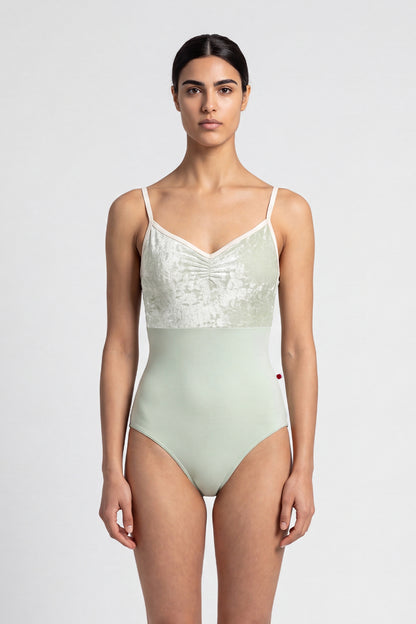 AI-generated model. Daniela Duo leotard, pale sage crushed-velvet ruched bodice with cream straps and a pale-green body.