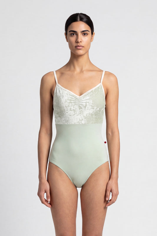 AI-generated model. Daniela Duo leotard, pale sage crushed-velvet ruched bodice with cream straps and a pale-green body.