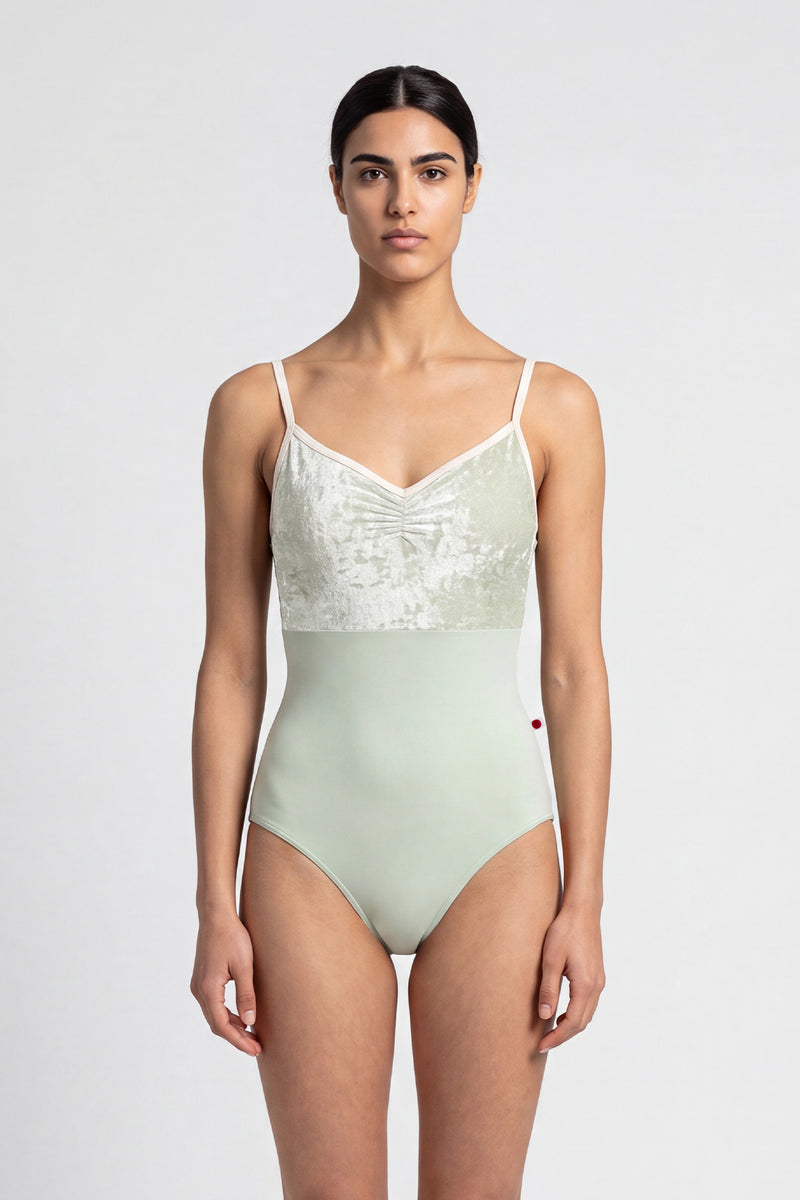 AI-generated model. Daniela Duo leotard, pale sage crushed-velvet ruched bodice with cream straps and a pale-green body.