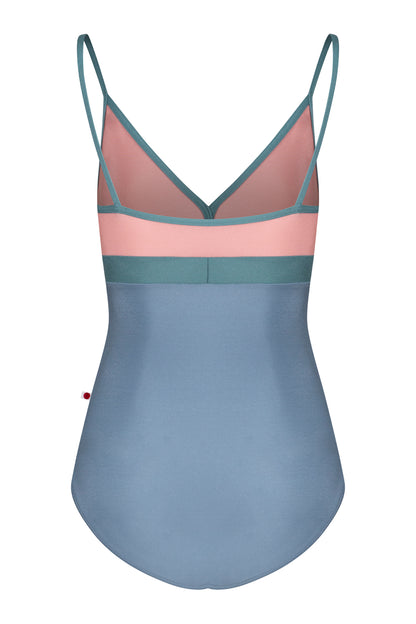 Zoe leotard, dusty-rose bust and blue-grey body with a teal waistband and thin teal straps, V-neck.