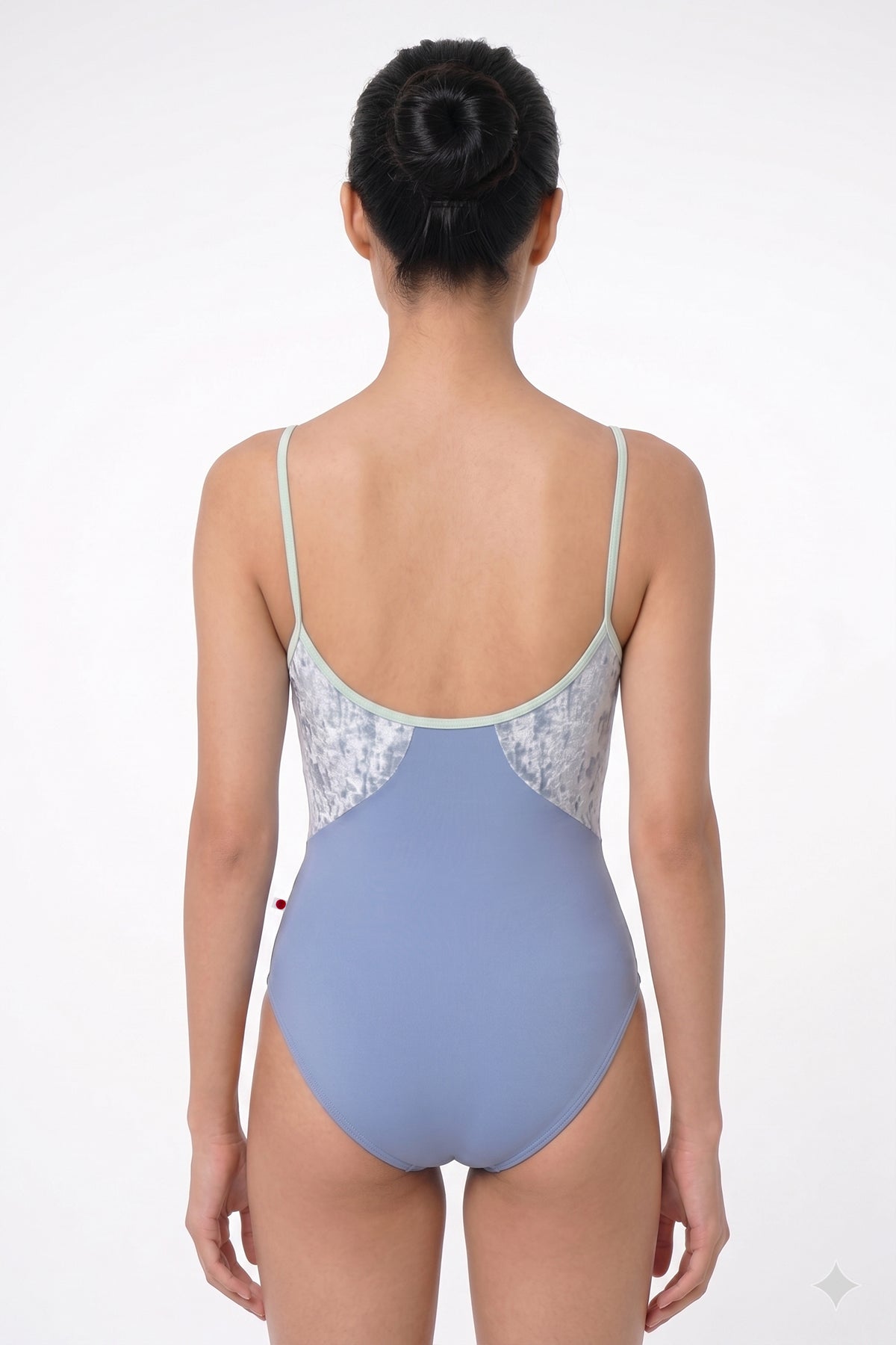 AI-generated model. Amanda leotard, silver-grey shimmer body color and a dusty blue-grey top with sage-green thin straps.