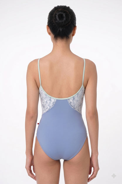 AI-generated model. Amanda leotard, silver-grey shimmer body color and a dusty blue-grey top with sage-green thin straps.