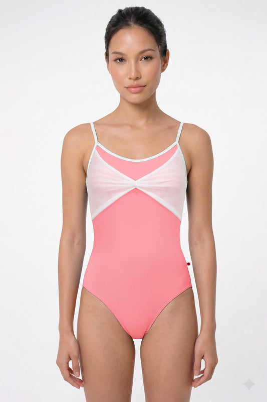 AI-generated model. Kathy leotard, coral-pink with a gathered white mesh bust panel and white trim.