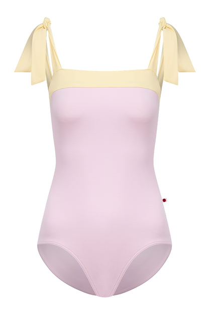 Mimi leotard, dusty pink body with a pale-yellow top band and knotted tie shoulder straps, square neckline.
