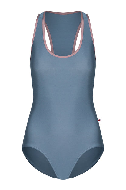 AI-generated model. Alex leotard, slate-blue with a scoop neckline and dusty-pink trim, racerback straps.