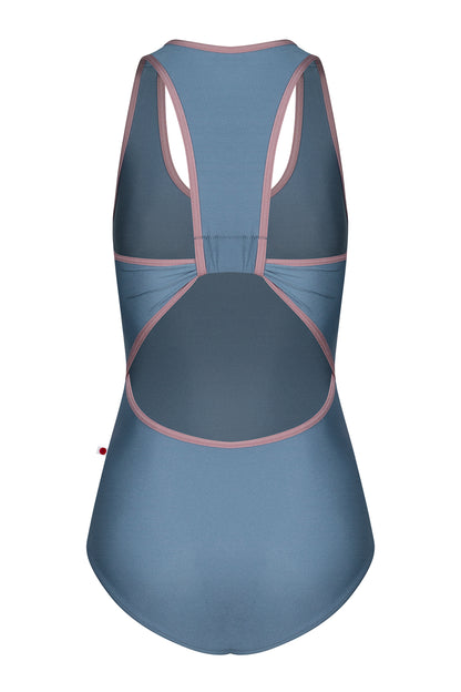 AI-generated model. Alex leotard, slate-blue with a scoop neckline and dusty-pink trim, racerback straps.
