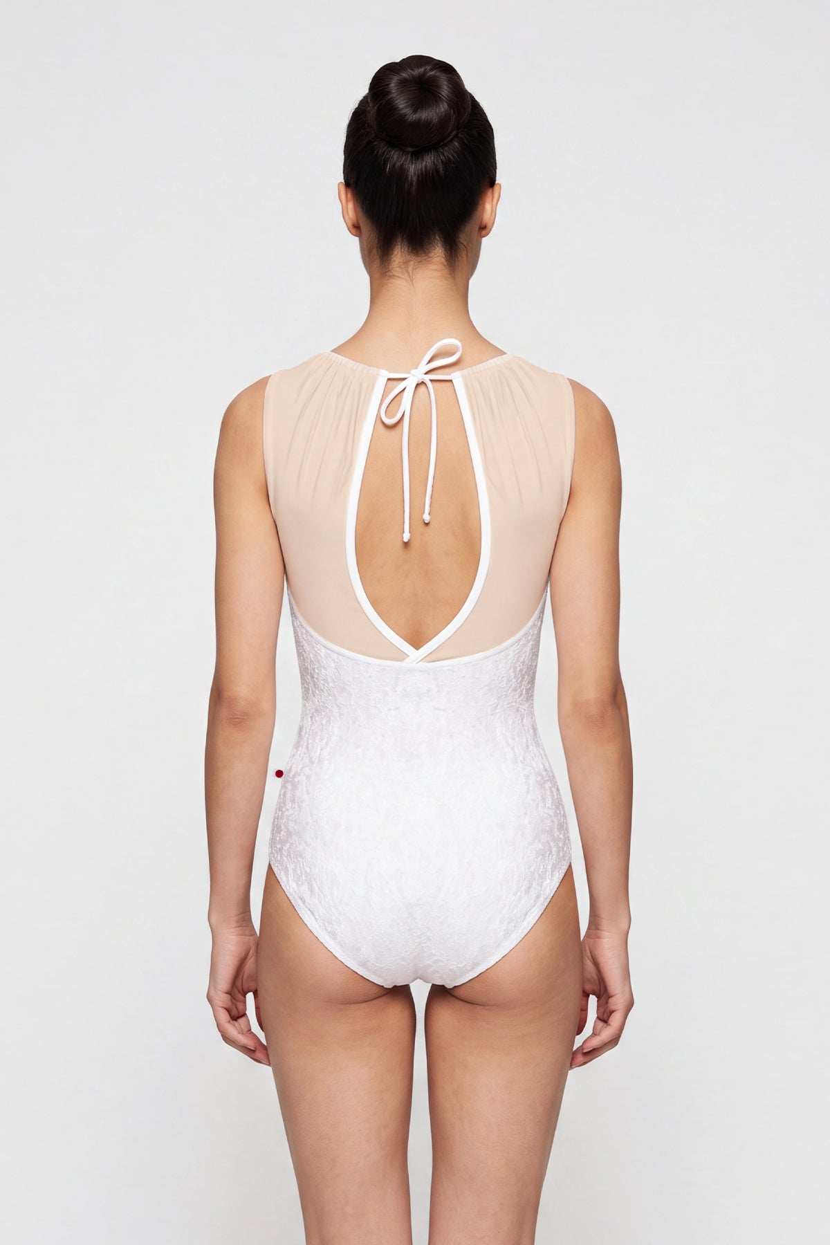 AI-generated model. Paris leotard in White, white velvet with a white gathered mesh boat neckline.
