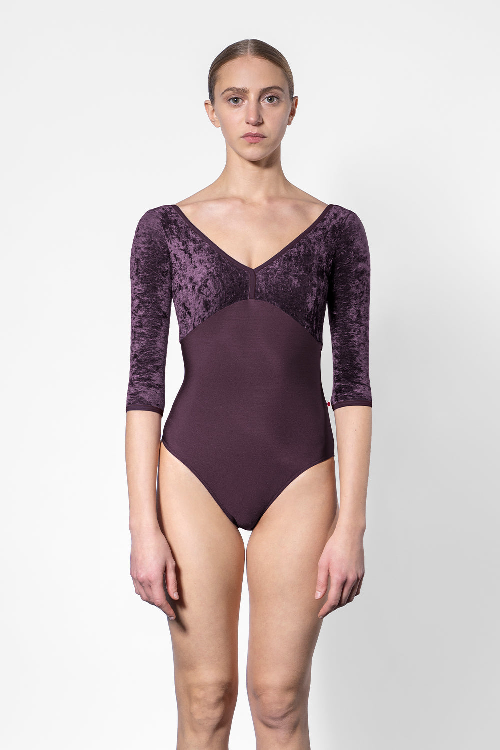 Alicia leotard in N-Eggplant body color with CV-Eggplant top color and N-Eggplant trim color. Features 3Q sleeves