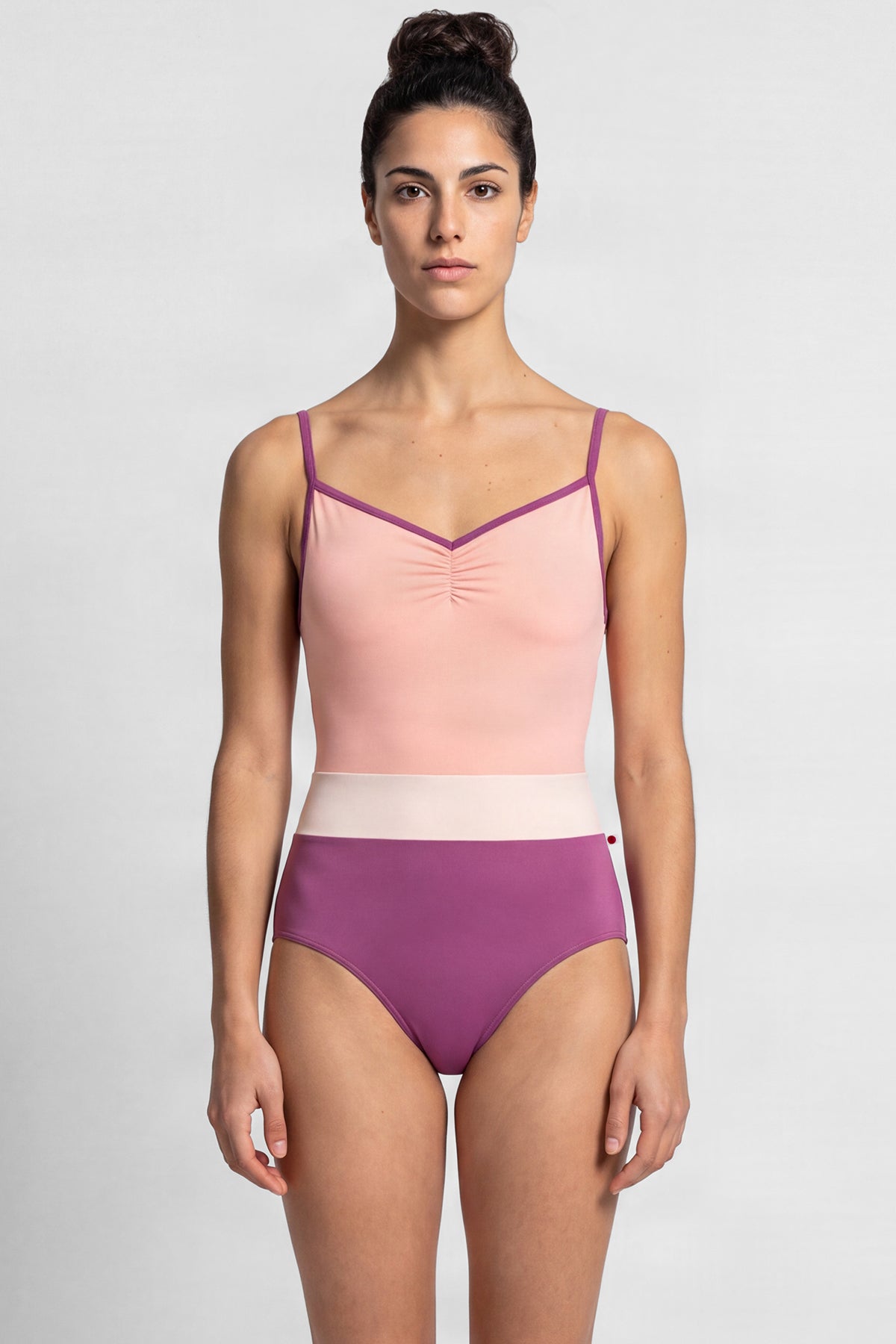 AI-generated model. Micah leotard, blush bodice and a magenta body with a pale-pink waistband, thin straps.